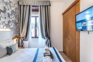 Postel nebo postele na pokoji v ubytování Roma dei Papi B&B