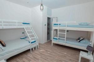 a room with two bunk beds and a table at NANA in Vlorë