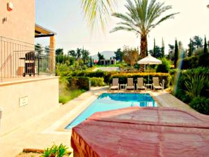 a swimming pool in the backyard of a house at Villa Samaliana Sandy Beach Villas - Private Pool - Jacuzzi - Private Beach Area in Polis Chrysochous