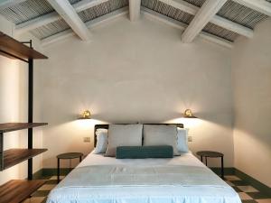 a bedroom with a large white bed with two tables at The Cathedral Retreats di Casa Camilla Journey in Otranto