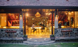 a restaurant with two people sitting at a table at Borderlands Adventure Center Weligama in Weligama