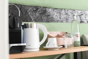 a shelf with a coffee maker and a bottle of wine at Casa BACCO in Rotenburg an der Fulda