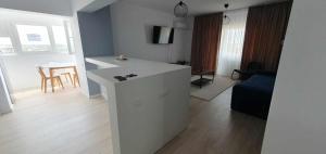 a kitchen and living room with a white counter top at Bella Vista Primavera 1124 in Bucharest +4 photos
