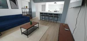 a living room with a blue couch and a table at Bella Vista Primavera 1124 in Bucharest