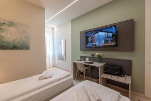TV a/nebo společenská místnost v ubytování Ile Hotel