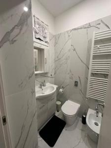 a white bathroom with a toilet and a sink at Wayhome apartment in Milan in Milan