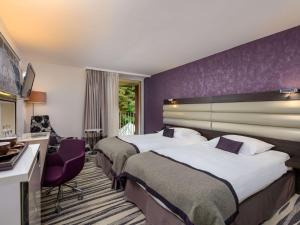 Mövenpick Hotel Lausanne客房内的一张或多张床位