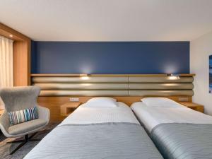 Mövenpick Hotel Lausanne客房内的一张或多张床位
