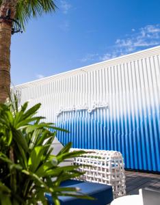 a blue and white building with a palm tree in front of it at Radisson Beach Resort Palm Jumeirah in Dubai