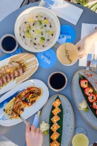 a blue table with plates of food on it at Radisson Beach Resort Palm Jumeirah in Dubai