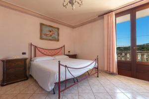 a bedroom with a bed and a large window at Casa Pireddu by BarbarHouse in Castro di Lecce