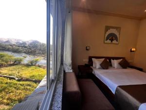Postel nebo postele na pokoji v ubytování Sambha Hotel