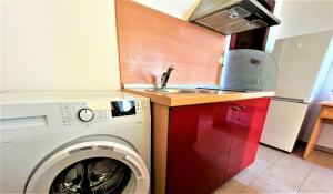 a kitchen with a washing machine and a sink at Miramar Apartment in Sunny Beach