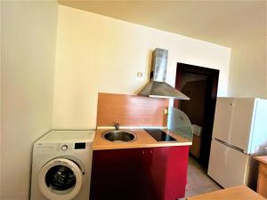 a kitchen with a sink and a washing machine at Miramar Apartment in Sunny Beach