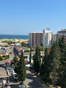 a city with a parking lot with trees and buildings at Miramar Apartment in Sunny Beach