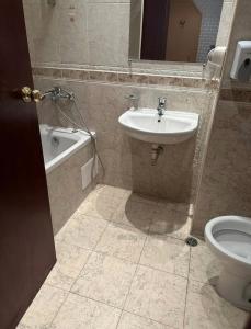 a bathroom with a sink and a tub and a toilet at Miramar Apartment in Sunny Beach +2 photos