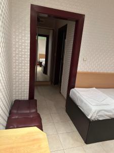 a bedroom with a bed and a mirror in it at Miramar Apartment in Sunny Beach