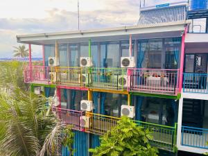a building with colorful balconies on the side of it at Rainbow Beach Mũi Né - Homestay & Coffee in Ấp Khánh Phước (1) +118 photos