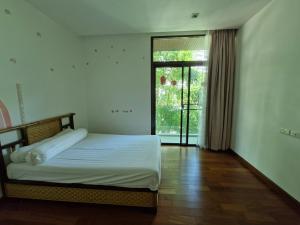 Postel nebo postele na pokoji v ubytování Palmeraiebeach Resort Rayong ปาล์มมาลี บีช รีสอร์ท ระยอง 罗勇棕榈树海滩酒店