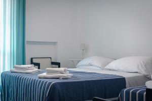 Un dormitorio con una cama con toallas. en Hotel Mediterraneo, en Guardia Piemontese Terme