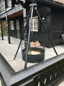a fire pit in the front of a building at Cozy Cabin Hovden Fjellpark 71 in Hovden