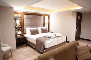 A bed or beds in a room at Amethyst Hotel
