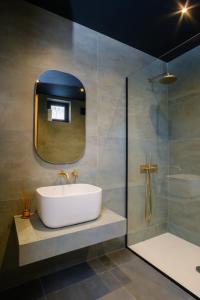 a bathroom with a sink and a shower with a mirror at Villa in Avlabari in Tbilisi City