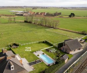 an aerial view of a large yard with a swimming pool at Countryhouse Blauw in De Panne