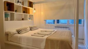 Ένα ή περισσότερα κρεβάτια σε δωμάτιο στο Elan Apartment
