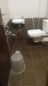 a bathroom with a sink and a toilet at Hotel raajasgrand in Tirupati +17 photos
