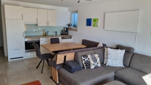a living room with a couch and a table at Ferienwohnung Mitterleithengut in Zell am See