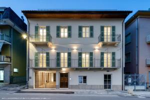 a large white building with balconies on a street at Cà d'la Mora in San Michele Mondovì