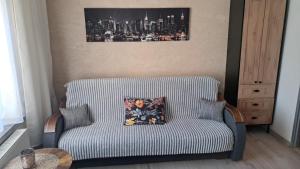 a couch with a pillow on it in a room at Garsoniera Kościuszki in Jasło +1 photo
