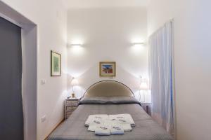 a bedroom with a bed with two towels on it at Don Nicola Tourist Location in Polignano a Mare