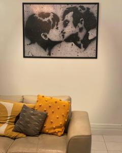 a picture hanging on a wall above a couch at CocknBull Boutique Hotel Echuca in Echuca