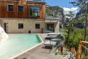 a house with a swimming pool in front of it at LA FORESTALE Luxury Ecolodge Piano Terra- Appt in Acqualagna