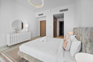 Krevet ili kreveti u jedinici u okviru objekta Magnificent - New 1BR in Canal Front Residences