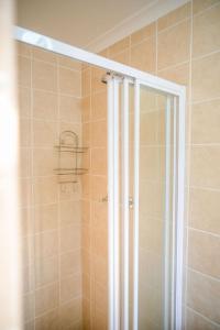 a shower with a glass door in a bathroom at At Skemer in Malmesbury +11 photos