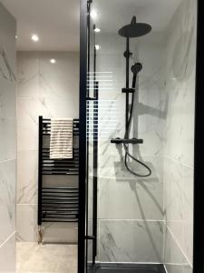 a shower with a glass door in a bathroom at Charming Cosy Cottage in Bollington Village in Bollington