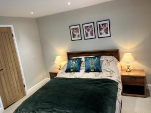 a bedroom with a bed with two night stands and two lamps at Charming Cosy Cottage in Bollington Village in Bollington