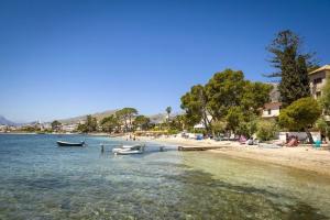 a beach with two boats in the water at Casa Vieja in Port de Pollensa