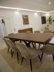 a wooden table and chairs in a living room at Résidence Bambou in Dakar