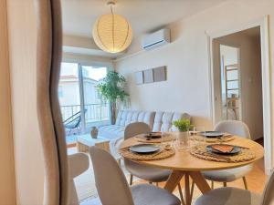 a dining room with a table and chairs and a couch at Casa Palmera in Sueca