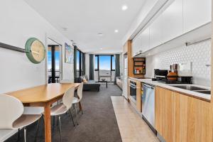 a kitchen and dining room with a table and chairs at Pool, Gym & Panoramic Views in Harrison