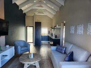 a living room with a couch and a table at Black Eagle's Rest #Unit 1-8 in Langebaan