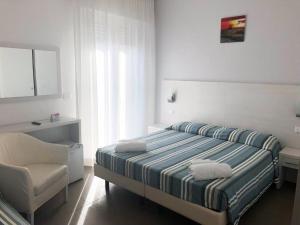Voodi või voodid majutusasutuse Hotel Gin sul mare toas