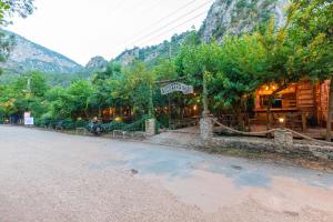 a building on the side of a street with a mountain at Sheriff, Olympos in Kumluca