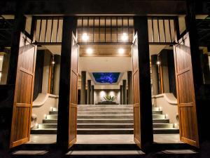 a hallway with stairs leading to a building at Andaman Cannacia Resort & Spa - SHA Extra Plus in Kata Beach