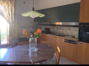 a kitchen with a table with a vase of flowers on it at Casa Melina in Nola