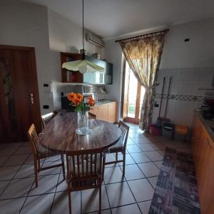 a kitchen with a table with a vase of flowers on it at Casa Melina in Nola